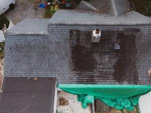 Storm damaged roof covered with a tarp